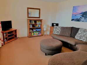 Golyfa Mor snug with brown corner sofa, foot stool and TV
