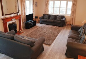 Lounge with 3 sofas, fireplace, tv
