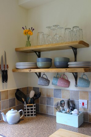 Glasses, cups, bowls and plates in the kitchen
