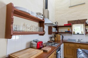 Kitchen, wooden shelves, cooker, small window