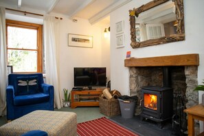 Sitting room with arm chair and TV