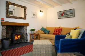 Sitting room with sofa, arm chair and foot stool