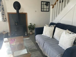 Sitting room with log burner, sofa and coffee table