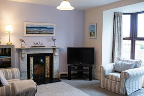 Sitting room with fireplace and armchairs
