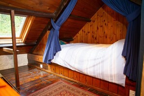Bed with wood surround and curtains