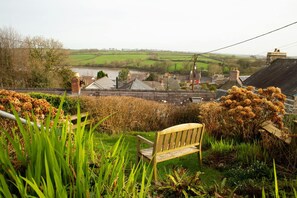 Garden at Maes yr Afon with bench and view over the Teifi Estuary