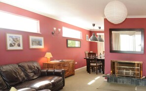 Living room with sofa, view of dining area