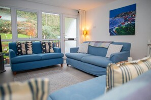 Living room with two sofas and views of the garden
