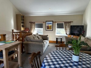 Dining table with chairs, sofa and TV