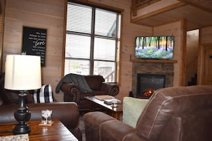 Living room with smart TV and electric fireplace.