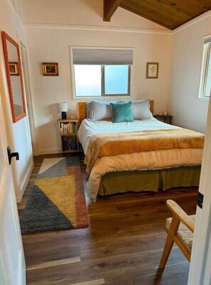 Bedroom featuring Queen-sized bed and blackout cellular shades.