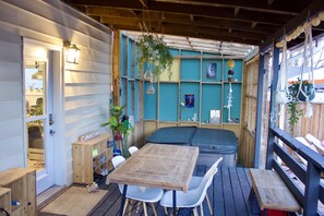 covered patio with hot tub