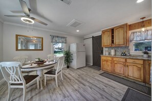 Dining area seats four and includes a full-size fridge for ample storage.