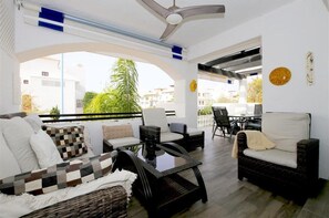 Large balcony with outdoor seating and dining area