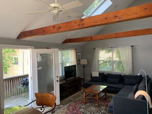 Living room with door to the long balcony deck on the left