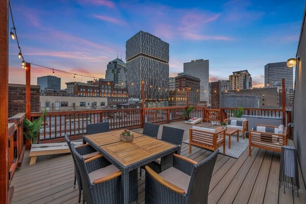 Find yourself captivated by the beauty of the skyline, where cityscape bliss meets a charming rooftop deck..