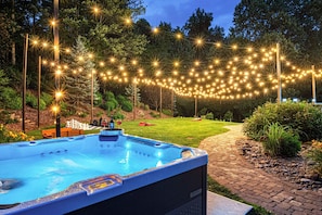 You soaking in the hot tub under twinkling lights - your perfect evening starts here.
