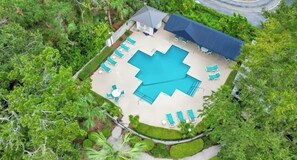 Arial view showcasing our pool area nestled among lush greenery - relaxation!