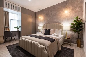 Discover serenity in our chic bedroom sanctuary, where sleek design elements and plush furnishings invite relaxation and rejuvenation.
