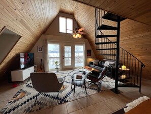 Huge windows and a balcony look out onto Lake Pepin from the A-Frame Cabin