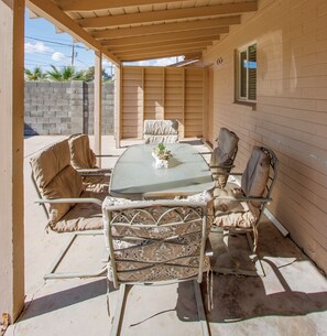 Al fresco dining in the patio area with 6 plush couches