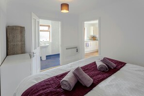 Bedroom and views through to bathroom and kitchen