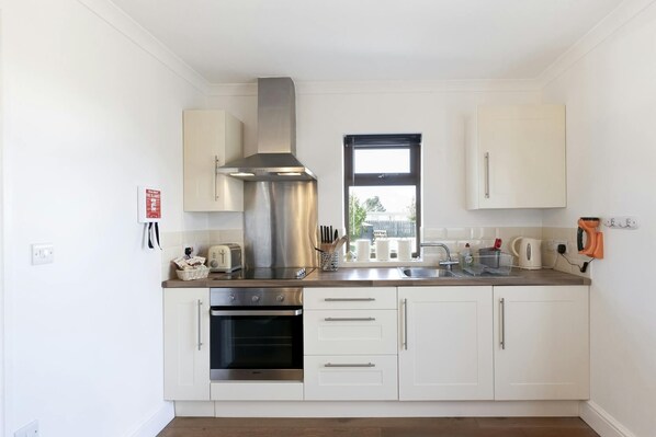 Oven and hob, extractor fan, cabinets and worktop