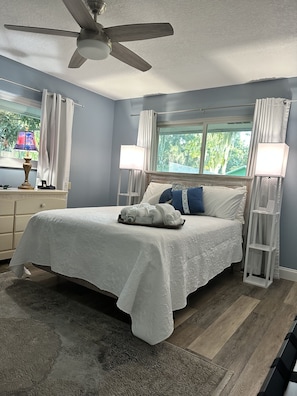 Master bedroom with soft white linens and towels.