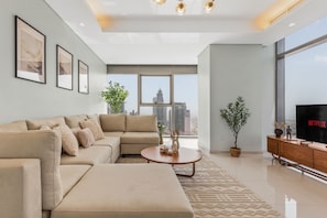 Panoramic views of Dubai's skyline and the sea from our expansive living room