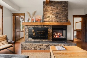 Living room with a gas fireplace, Smart TV with cable & cozy seating options