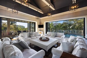 Let the outdoors in- expansive sliding doors open to the pool deck