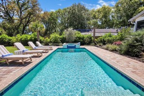 The Backyard Features a Saltwater Pool and Spa