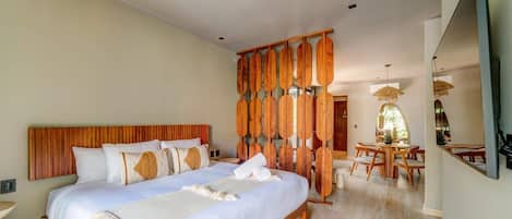 A plush king bed with quality linens and wall-mounted Smart TV