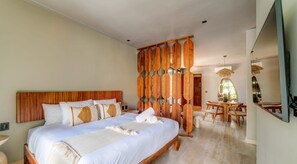 A plush king bed with quality linens and wall-mounted Smart TV