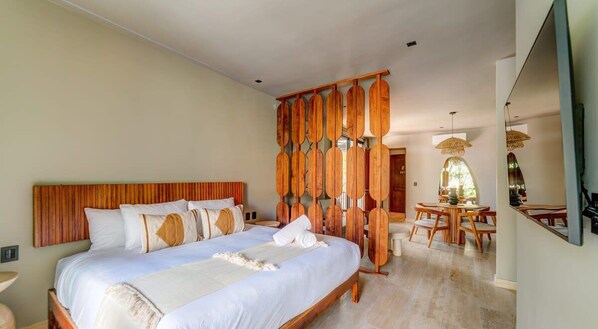 A plush king bed with quality linens and wall-mounted Smart TV