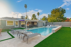 Brand-new backyard with heated pool and hot tub.