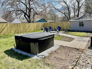 Fully fenced in back yard with hot tub & fire pit!