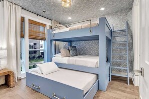 The bedroom features a large closet, SmartTV, and full en suite bathroom