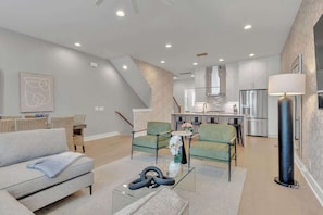 The living room features plenty of comfy seating and a large SmartTV for easy login to all your streaming services.