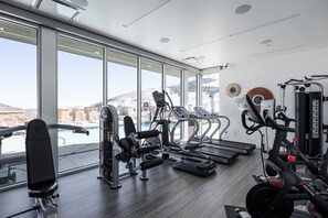 - Fitness center with treadmills, Peloton bikes, and weight machines  
- Floor-to-ceiling windows overlooking pool and mountain slopes  
- Fully equipped gym for workouts during your mountain getaway