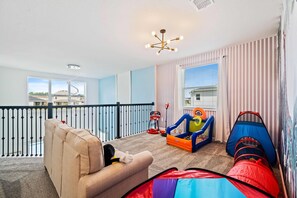 Comfy Loft area of the Apartment in Kissimmee Florida - Loft area with games for kids  - Create unforgettable memories - Cozy seating  - Elegant Lighting