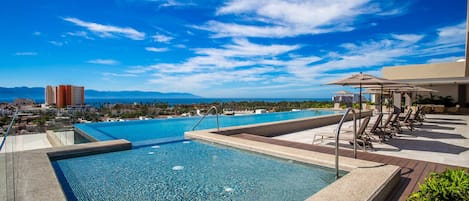 Roma Encore amenities include an infinity pool, a children's pool, gym and BBQ area, all with amazing scenic views