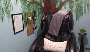 Snuggle into a cozy throw beneath a “Thankful” pillow and enjoy a moment of peace. This thoughtful setup includes mounts for your remotes and phone, so everything you need is within reach. A perfect blend of comfort, gratitude, and convenience.