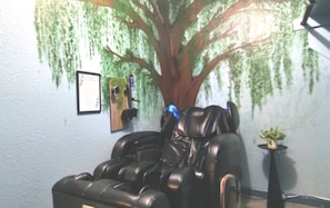 Relax in luxury with our Cozzia CZ-628 massage chair, set beneath a stunning hand-painted willow tree mural that wraps around two walls. This tranquil corner creates a spa-like oasis, perfect for easing sore muscles and unwinding after your Dallas adventu