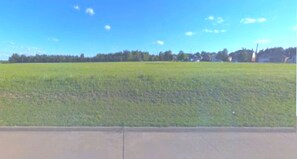 Enjoy the perfect balance of peace and play. With no neighbors directly across the street, the setting offers a tranquil, relaxing atmosphere. The open field out front provides ample room for children and pets to roam freely and safely enjoy the outdoors.