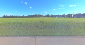 Enjoy the perfect balance of peace and play. With no neighbors directly across the street, the setting offers a tranquil, relaxing atmosphere. The open field out front provides ample room for children and pets to roam freely and safely enjoy the outdoors.