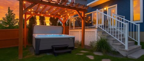 Unwind under the glow of string lights in your private spa oasis