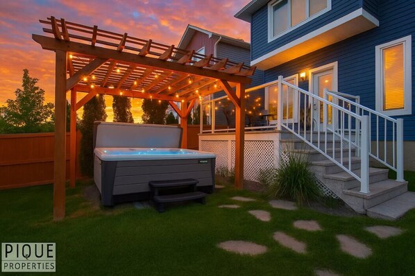 Unwind under the glow of string lights in your private spa oasis