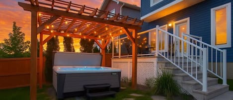 Unwind under the glow of string lights in your private spa oasis