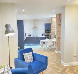 Open plan living, view from lounge towards kitchen and dining area
